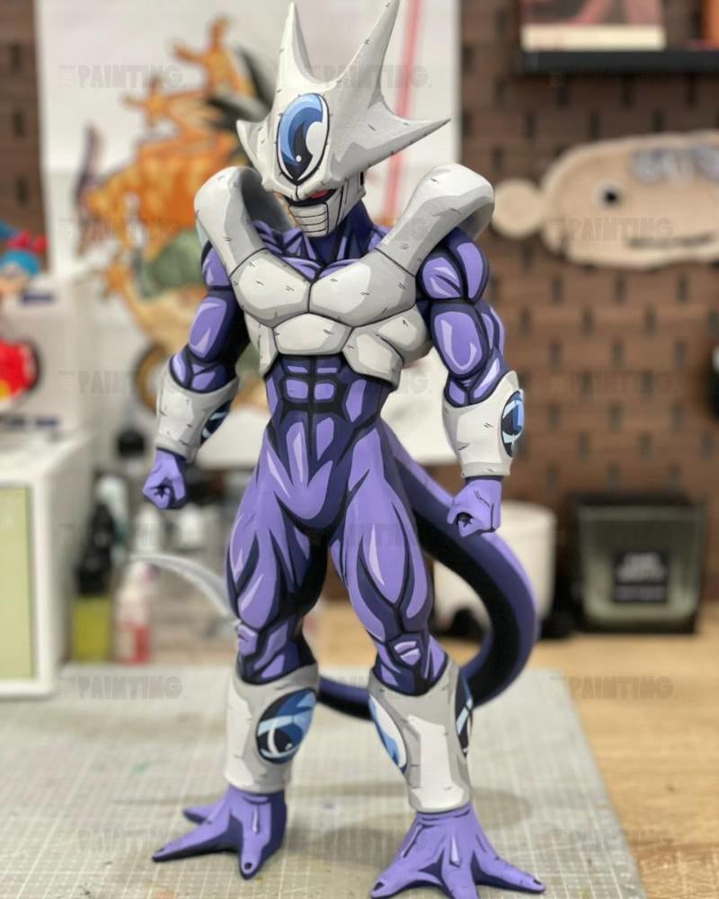 A painted Dragon Ball Z action figure of Frieza, standing on a cutting mat in a hobby room setting.