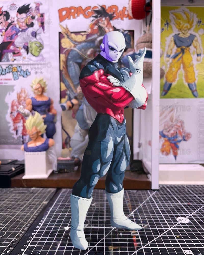 A Dragon Ball figure of the character Zonk standing on a gridded cutting mat, with Dragon Ball posters and a display stand in the background.
