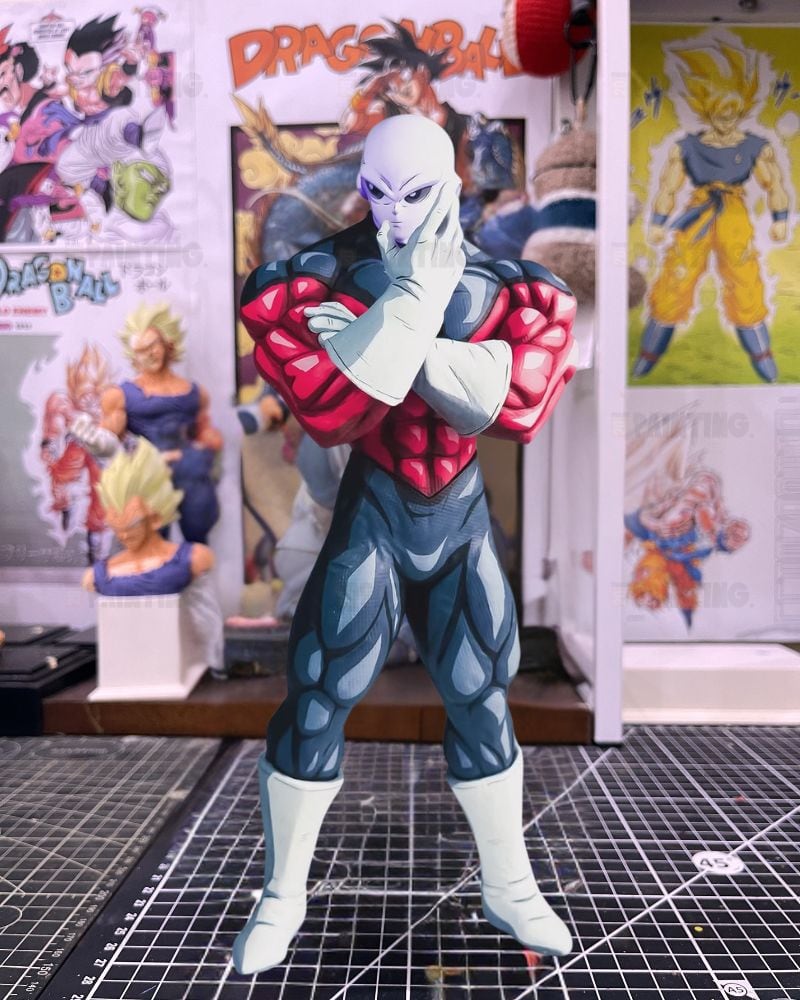 A Dragon Ball Z anime figure of the character King Kai, standing in a detailed collector's room with Dragon Ball posters in the background.