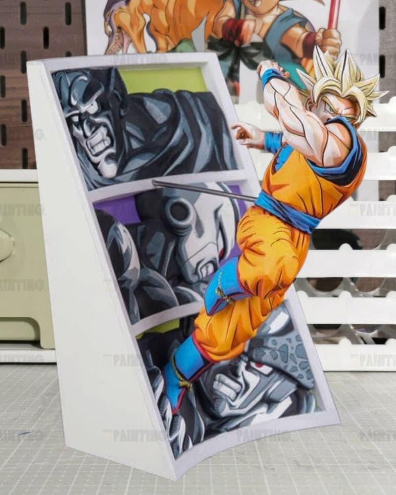 A 3D pop-up cardboard art piece featuring characters from Dragon Ball Z, including Goku in his Super Saiyan form and a dark robotic character, set against a white slatted background.