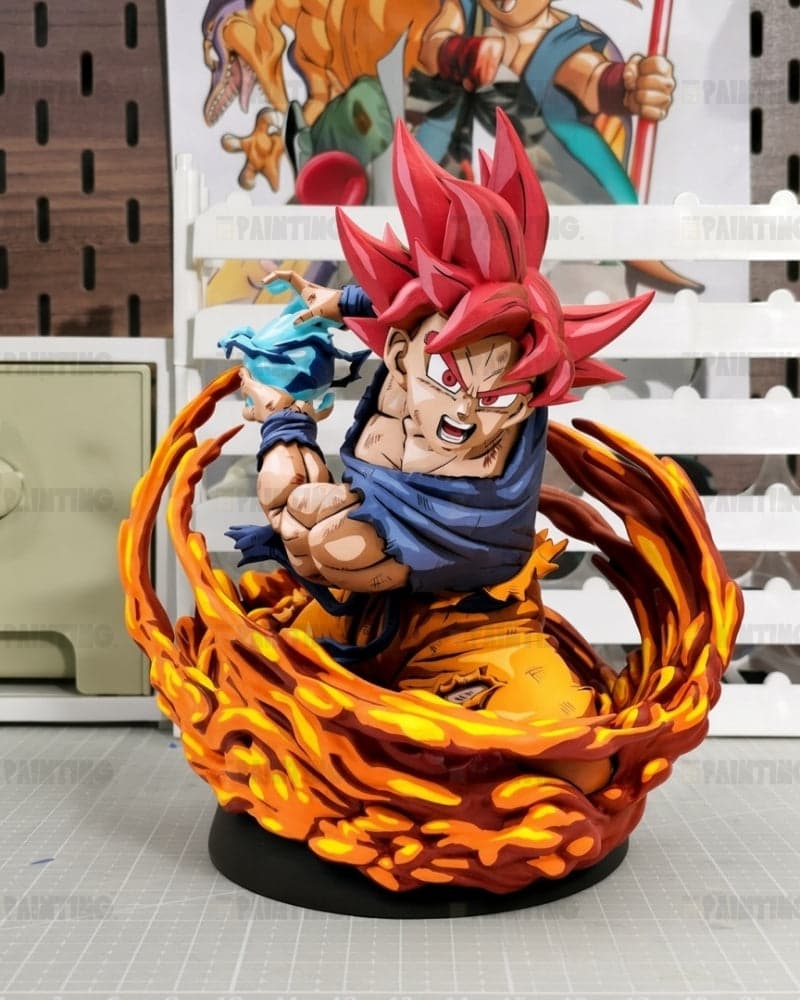 A detailed collectible figurine of Goku in his Super Saiyan form, seated inside a swirling orange and yellow flame-like base on a black round stand. The background shows a white slatted shelf with a Dragon Ball poster and a pegboard.