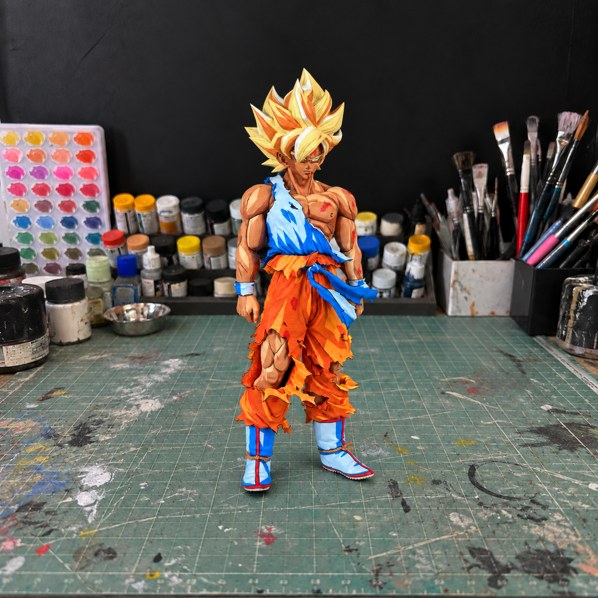 Goku SMSP Battle Damaged — hand-painted figure in artist workshop