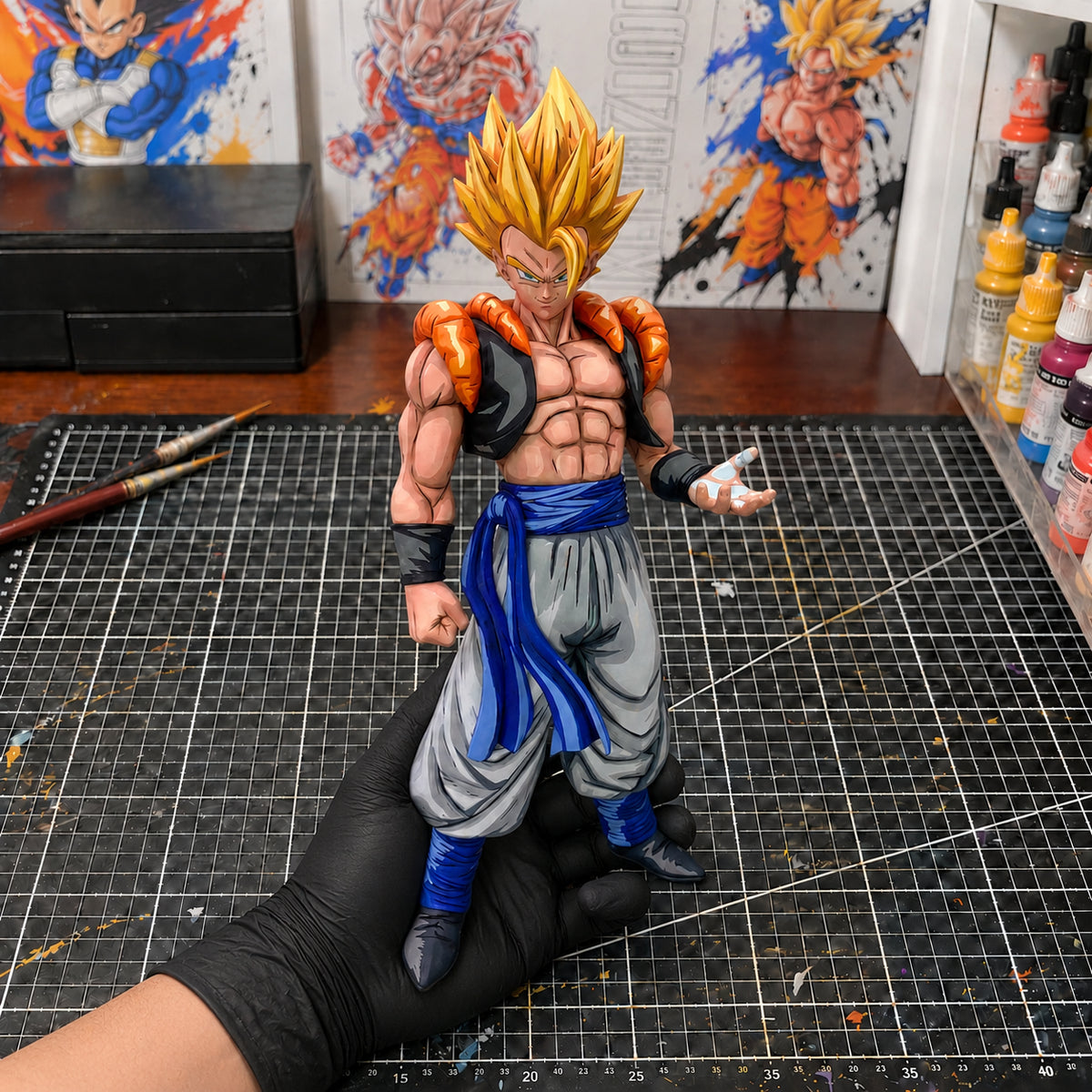 Dragon Ball Super Nero Gogeta 2D Anime-Style Figure Repaint — held securely in one gloved hand in the workshop