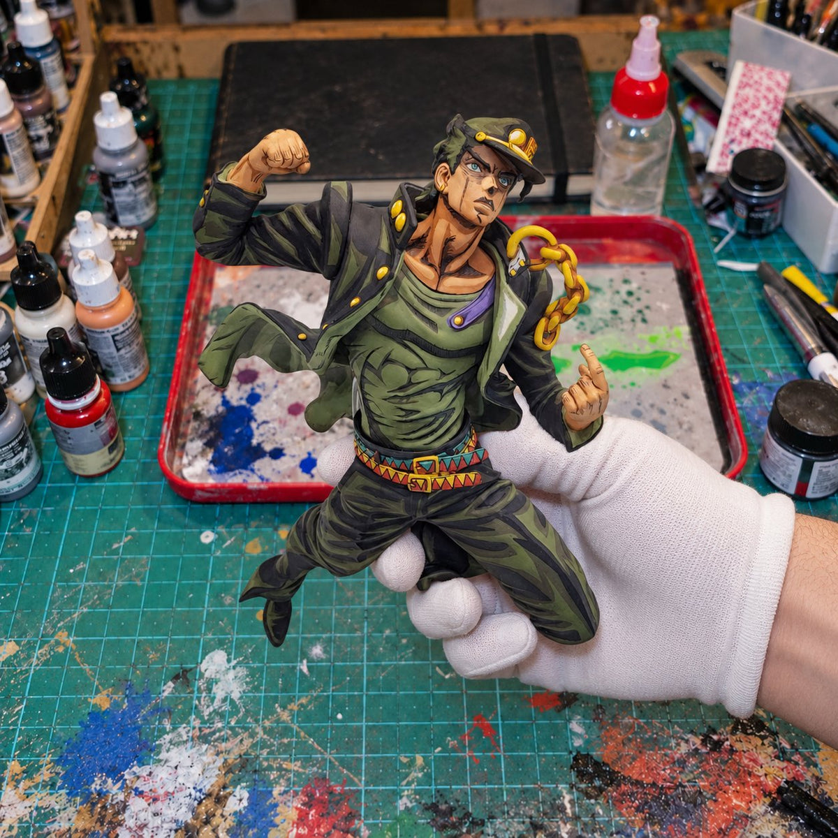 Jotaro Kujo 2D Painted Figure – Raised-Fist Pose — painted figure in a miniature painting workshop
