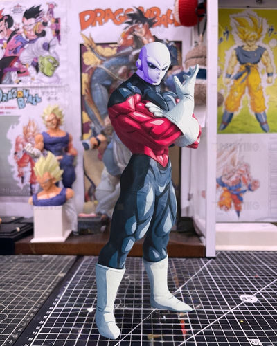 A Dragon Ball figure of the character Zonk standing on a gridded cutting mat, with Dragon Ball posters and a display stand in the background.