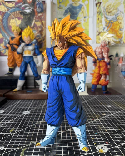 A Super Saiyan Gohan action figure from Dragon Ball Z stands on a gridded cutting mat in a collector's room, with other anime figures and posters blurred in the background.
