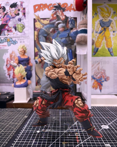 A detailed collectible action figure of a Super Saiyan Gohan from Dragon Ball, posed dynamically on a cutting mat with Dragon Ball posters in the background.