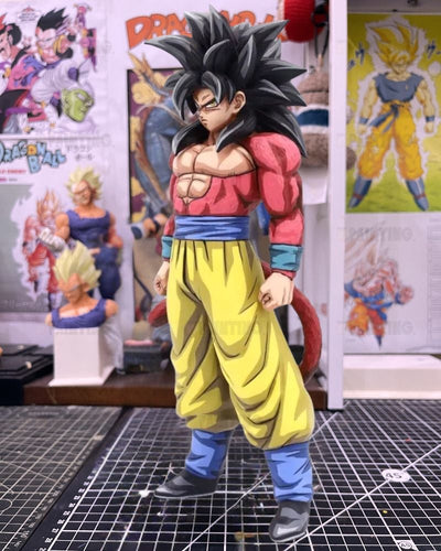 A detailed collectible figure of Goku in his Super Saiyan form, standing on a gridded cutting mat in a collector's room with Dragon Ball posters and figurines in the background.