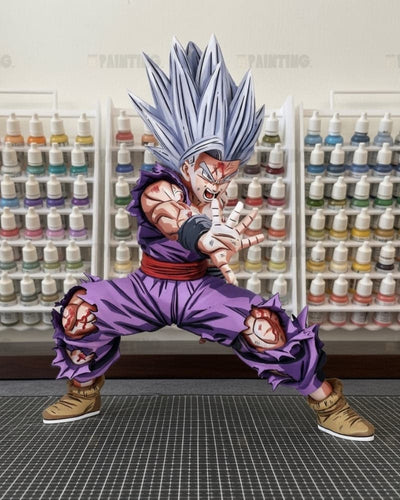 A detailed collectible figure of a Super Saiyan character in a dynamic pose, standing on a gray grid mat with shelves of colorful paint bottles in the background.