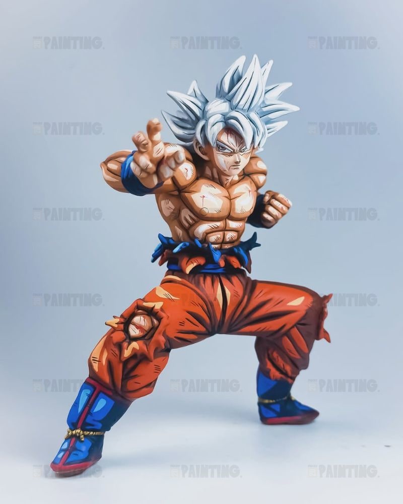 A painted collectible figurine of Goku in his Super Saiyan form, posed in a dynamic fighting stance against a light gray studio background.