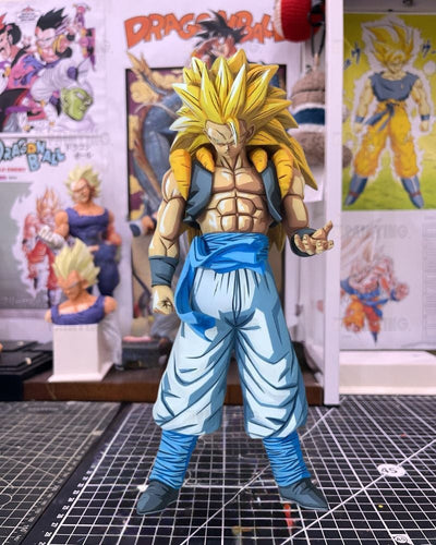 A Dragon Ball figure of Gohan in a Super Saiyan form, standing on a black gridded cutting mat with Dragon Ball posters and art prints in the background.