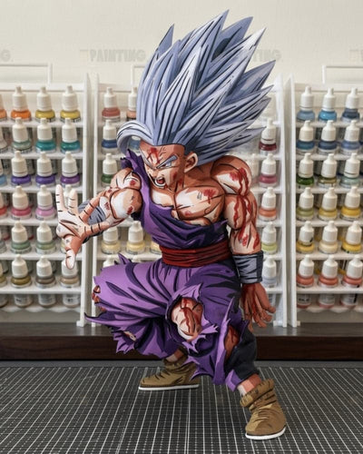 A highly detailed collectible action figure of Goku in a Super Saiyan form, posed dynamically in a crouching stance. The figure features spiky silver hair, a purple gi, and a muscular, battle-scarred skin with red markings.