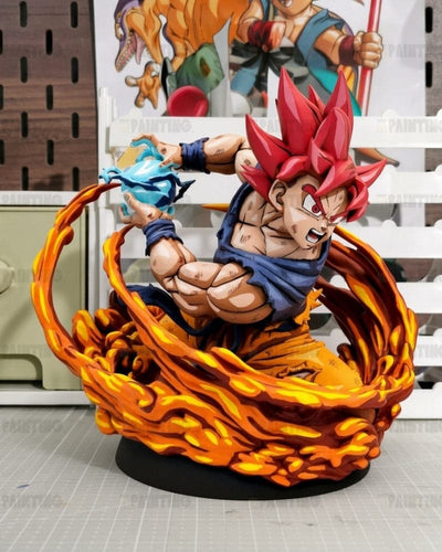 A detailed collectible figurine of a Super Saiyan character in a dynamic pose, surrounded by a swirling orange and yellow energy effect on a black base. The figure has spiky red hair, a blue torn gi, and is holding a blue energy ball.