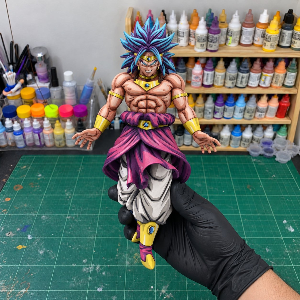2D Anime Colour Super Saiyan Broly Figure Repaint — painted figure in a miniature painting workshop