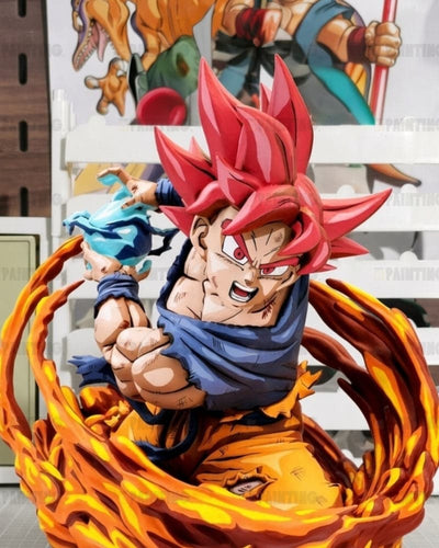 A detailed collectible statue of Goku in a Super Saiyan form from Dragon Ball, surrounded by a swirling orange and yellow flame-like energy effect, with a blue energy ball in his other hand, set against a white shelving background.
