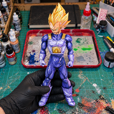 Hand-painted Vegeta SSJ figure — workshop setting