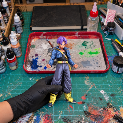 Trunks Base — hand-painted figure in artist workshop