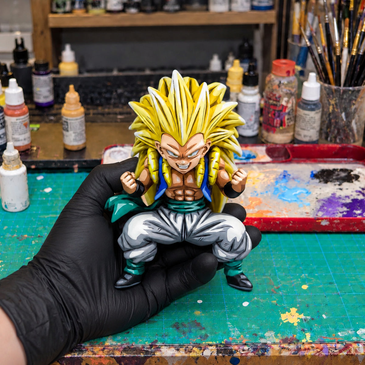 Blood Saiyans Special Gotenks Super Saiyan 3 Figure Repaint — held securely in one gloved hand in the workshop