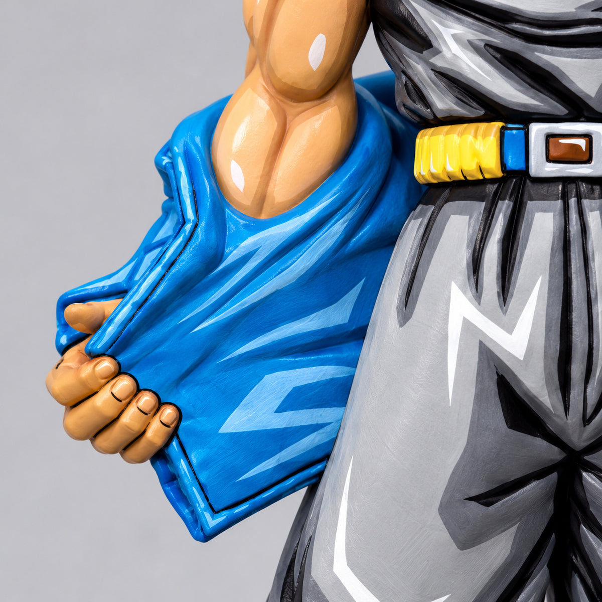 Dragon Ball Super Saiyan Trunks Figure Repaint — Hand holding lowered blue jacket