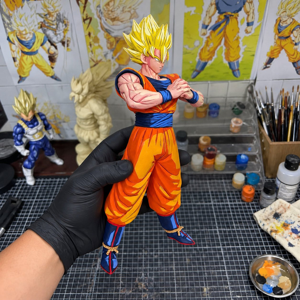 Dragon Ball Super Saiyan Son Goku Figure Repaint — Front-Facing Pose — painted figure in a miniature painting workshop