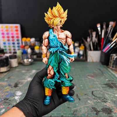 Dragon Ball Z Son Goku Namek Figure Repaint — held securely in one gloved hand