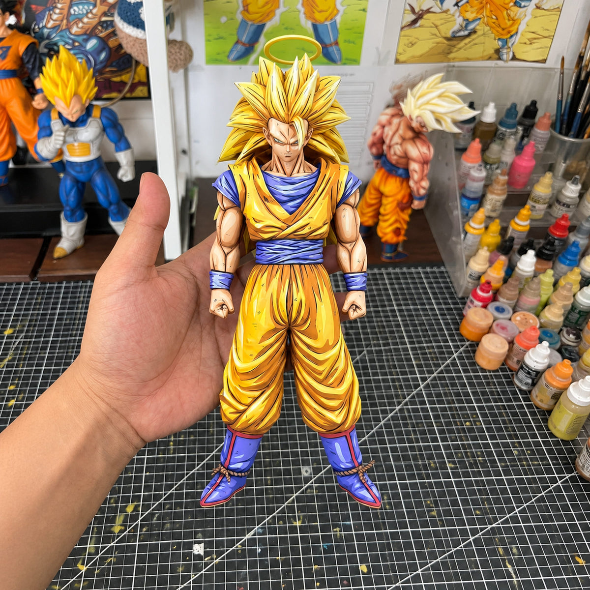 Super Saiyan 3 Goku 2D painted collectible, figure held in hand