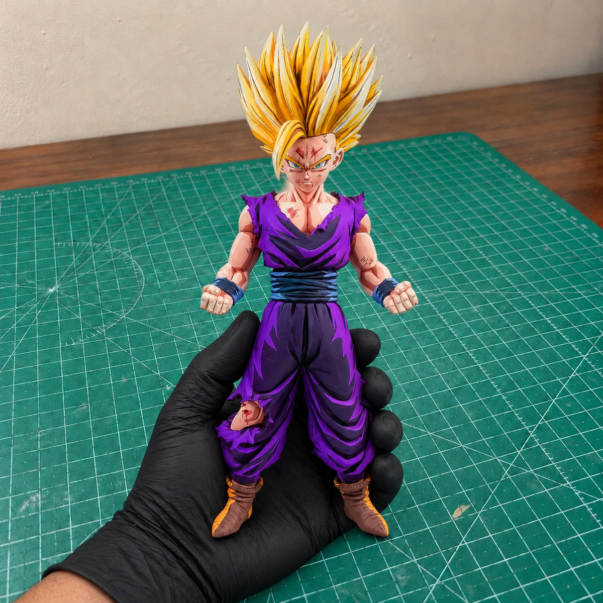 2D Colour Dragon Ball Super Saiyan 2 Son Gohan Figure Repaint — held securely in one gloved hand